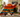 Two girls and an adult building a giant rainbow dinosaur with jumbo Biggo Blocks, using extra large building blocks for collaborative STEM learning and creative play indoors.
