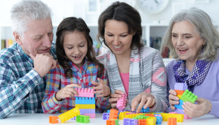 Grandparents and grandchildren bond over creative play with building blocks, sharing smiles and stories while stacking colorful blocks together.