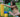 A girl building with colorful blocks on the grass, focused on stacking a yellow block. 