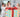 Two children and a woman excitedly unwrapping a big birthday gift with colorful wrapping and bows. 