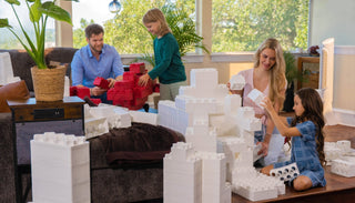 Family having fun with white jumbo building blocks.