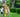 Three children working together to build a tall tower using colorful extra-large building blocks in a backyard setting.
