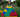 Smiling young girl building a colorful pyramid with oversized Biggo Blocks on a lush green lawn, demonstrating the joy and creativity inspired by sensory play outdoors.