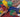 Close-up of hands storing colorful building blocks after a group play session.