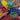 Close-up of hands storing colorful building blocks after a group play session.