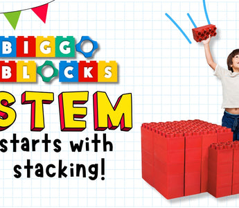 Excited child lifts red jumbo blocks above a large block structure with the words “STEM starts with stacking!” featured in colorful Biggo Blocks branding.