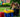 Two girls read a book together at a tea party setup made entirely of Biggo Blocks in a backyard garden.