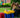 Two girls read a book together at a tea party setup made entirely of Biggo Blocks in a backyard garden.